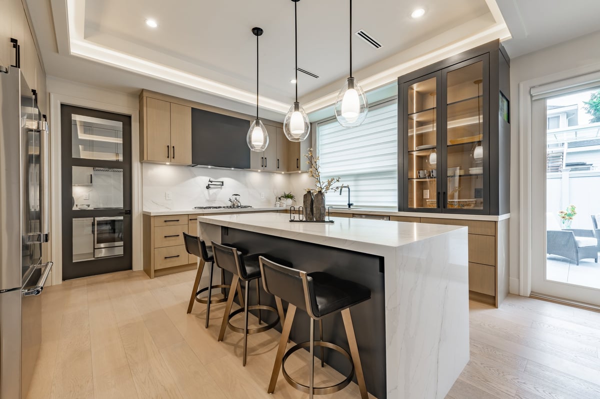 Freshly completed kitchen extension interior with wooden cabinets and pendant lighting